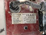 a close up of a red machine with a label on it