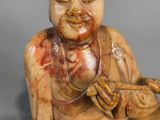 an image of a statue of a person sitting on a table
