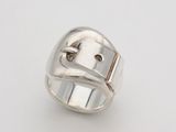 a close up of a silver ring on a white surface