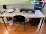 a computer desk with a printer on it in a room