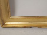 an image of a gold frame on a wall with a white background