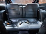 the back seats of a car with a remote control in the passenger seat