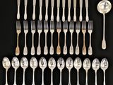 a lot of silver spoons and forks on the table