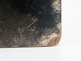 a piece of wood that has been scratched and is sitting on a white surface