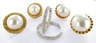 four pieces of jewelry including a ring, earrings and a ring