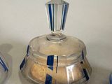 two glass jars with blue and white designs on them