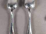 two spoons that are sitting on a table