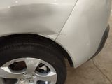 a close up of a car ' s tire with a denting on it