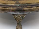 a gold plate with a bird on top of it