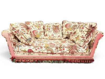 an image of a floral couch with pillows on it