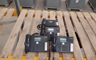 three phones sitting on a pallet next to each other