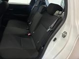 the back seats of a white car with a black seat belt