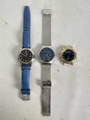 two watches and a watch on a white surface with a blue strap