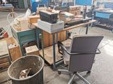 a chair that is sitting next to a table in a room