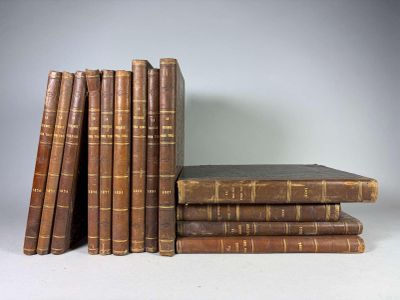 several old books stacked on top of each other on a table