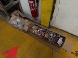 a box of cans and cans of soda sitting on the floor