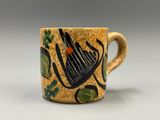 une tasse à café sur laquelle est représenté un instrument de musique