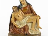 an image of a figurine of a woman holding a man on her lap