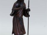 statue of a man holding a staff and a staff in his hand