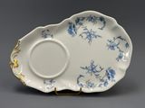 a close up of a blue and white plate on a stand