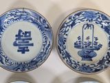 three blue and white plates with oriental designs on them on a table
