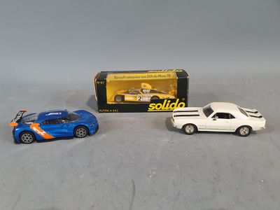 two toy cars are sitting next to each other on a table