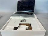 a white box with a laptop and a charger in it