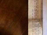 a piece of paper on a table with a calculator next to it