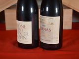 two bottles of wine sitting next to each other on a table