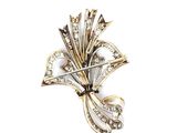 an image of a brooch with diamonds and pearls on a white background
