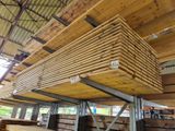 a large stack of lumber stacked on top of each other in a building