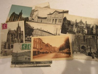 many old postcards of old buildings on the table