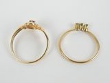 two gold rings with diamonds on them