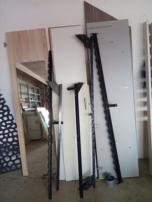 several skis and poles are leaning against a wall in a room