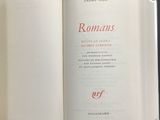 an open book with a picture of a roman script on it