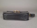 an image of a black purse on a table