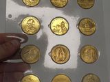 a person holding a piece of gold coins in their hand