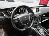 the interior of a car with a steering wheel and dashboard controls