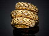 a close up of a gold ring with diamonds on a black surface