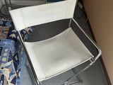 a white folding chair in the corner of a room
