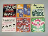 several beatles albums are arranged on a white surface