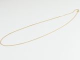 a gold chain necklace with a single diamond on a white background