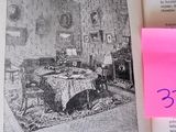 a pink post it note on a book with a picture of a living room