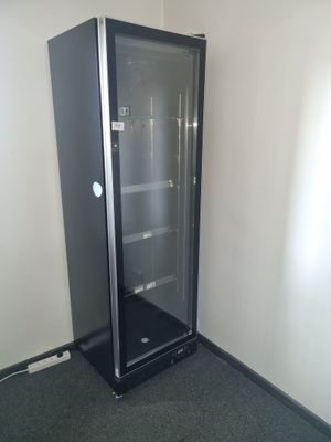 an image of a glass door refrigerator in a room