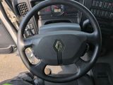 the interior of a car with a steering wheel and dashboard controls