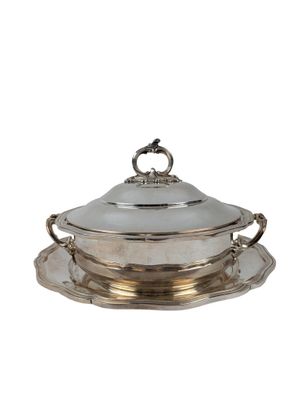 a silver plate with a silver lid and a saucer on it