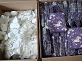 a cardboard box filled with lots of purple and white items