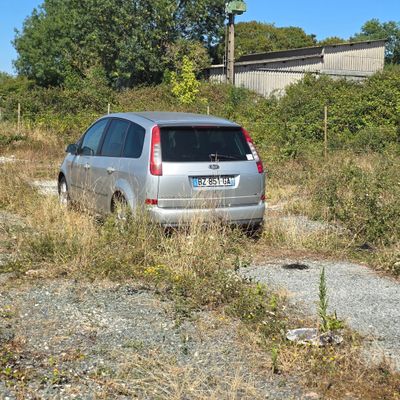 a silver car that is parked in the grass