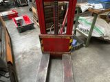 a fork lift truck that is parked in a garage