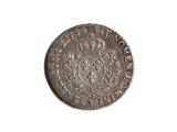 a close up of a coin on a white surface
